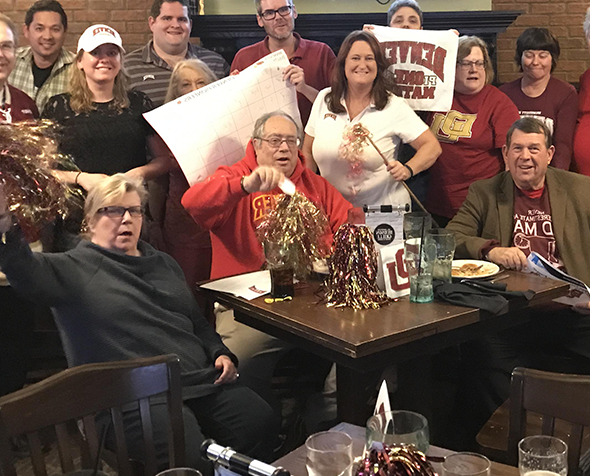 Alums of different ages with DU gear 和 pom poms